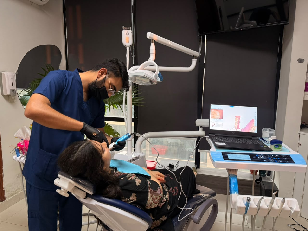Dr. Mamoon Pasha treating a patient at MM Dental Associates